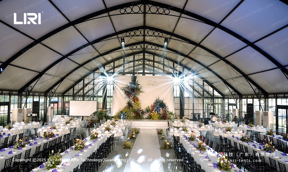 Wedding tent decorations with lighting and floral arrangements