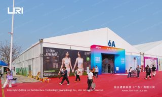 Well-lit gallery walls inside the temporary event marquee
