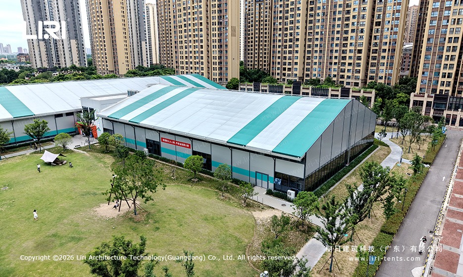 Indoor basketball court tent interior - polished sports flooring, LED lighting, ceiling fans, regulation hoops