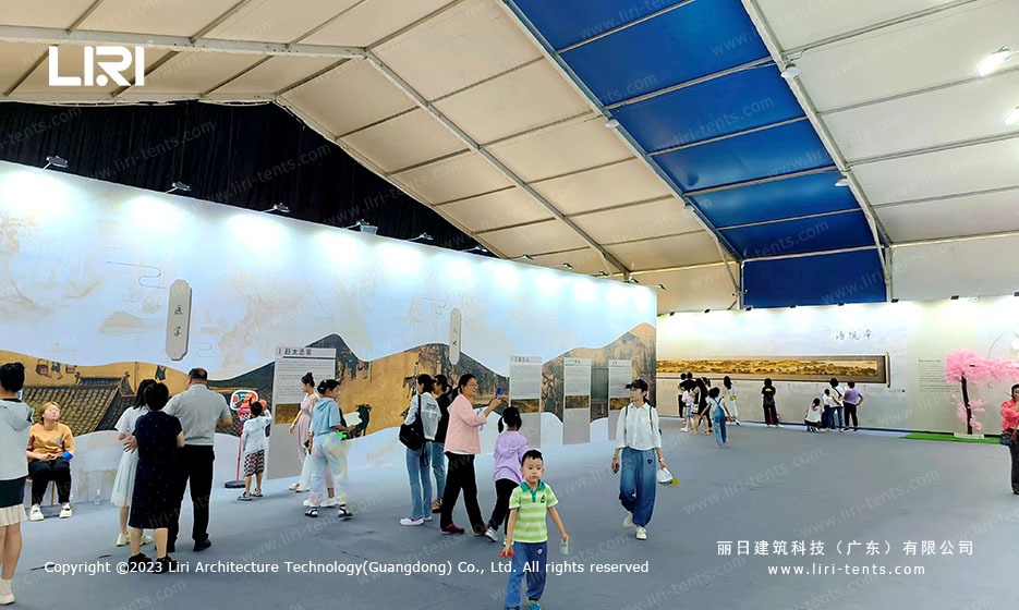 Visitors walking through the marquee interior with Qingming Scroll mural