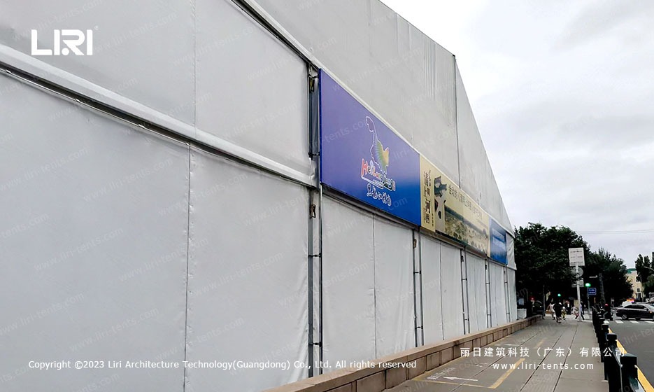 Clear span marquee exterior with Hailan Pavilion banner along city street