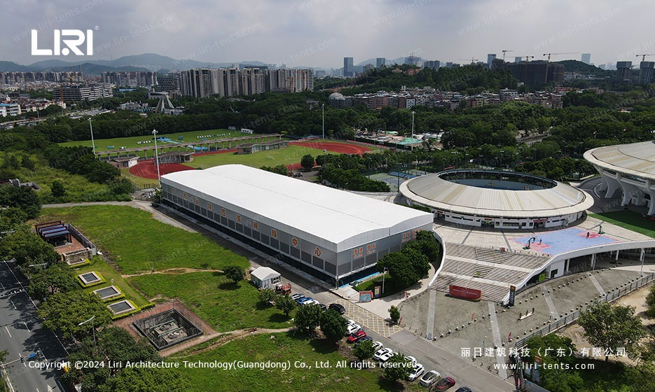 Aerial view of large TFS curve structure tennis court marquee covering eight outdoor courts