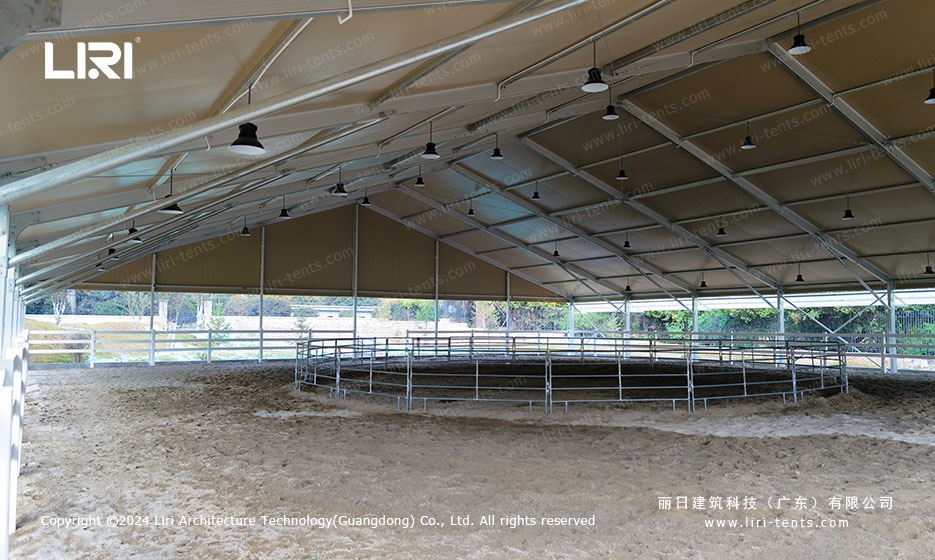 Round pen inside the equestrian marquee with sand surface and steel railing