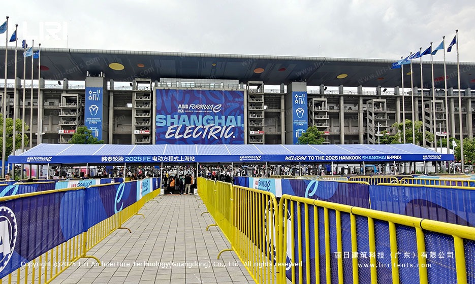 Welcome banner over the main entrance blue roof marquee gate with queueing barriers at the Shanghai E-Prix