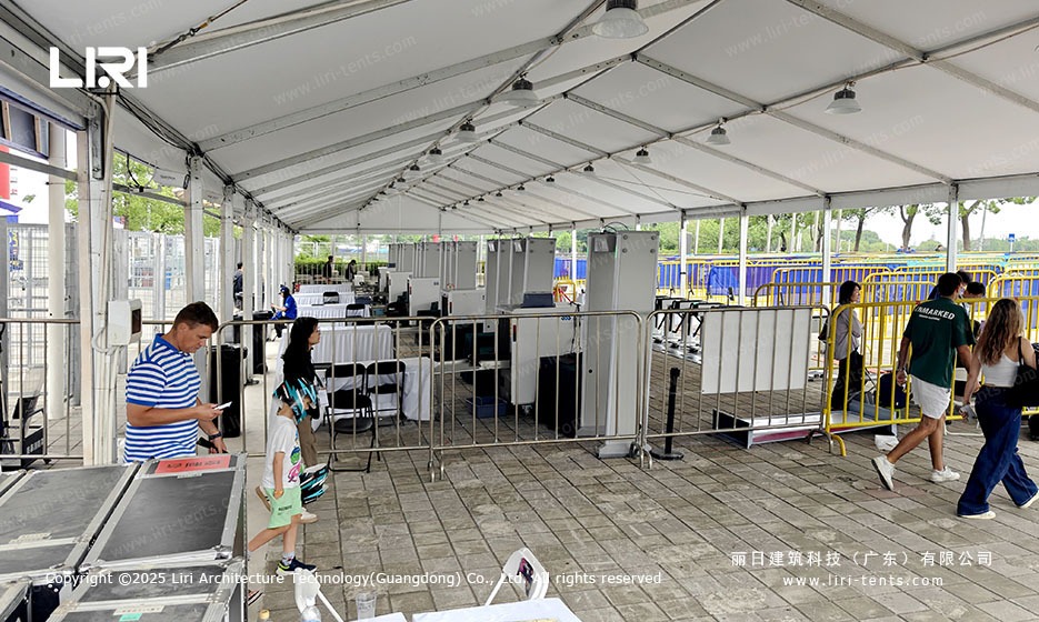 Race entry turnstiles inside white A-frame marquee with ceiling fans at the ABB Formula E Shanghai E-Prix