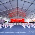 white chair ceremony seating layout inside large event marquee tent