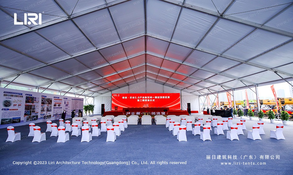 white chair ceremony seating layout inside large event marquee tent