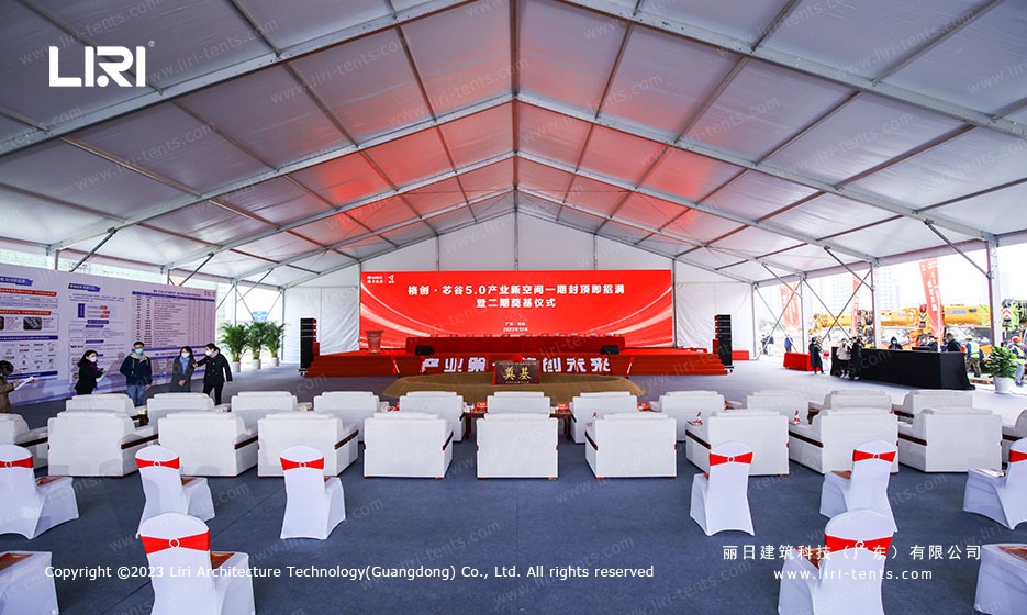 white chair ceremony seating layout inside large event marquee tent