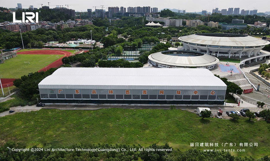 Exterior view of large TFS sports marquee adjacent to athletic stadium