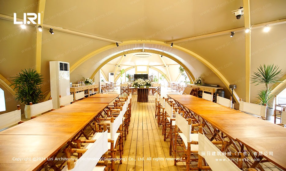 Luxury dining interior with wooden tables under tension membrane roof