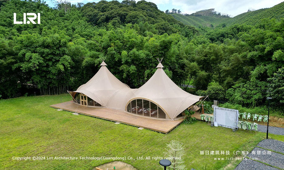 Twin peak tension membrane marquee tent at forest resort