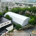 Aerial view of polygon tennis court marquee with arcum roof on a city sports facility