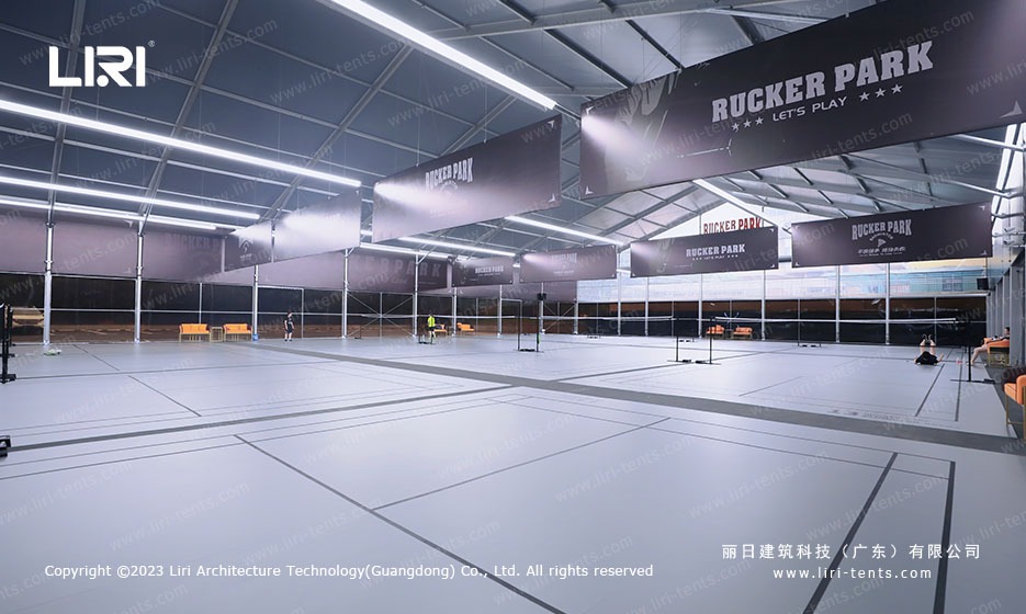 Multiple badminton courts inside aluminum frame marquee with LED strip lighting