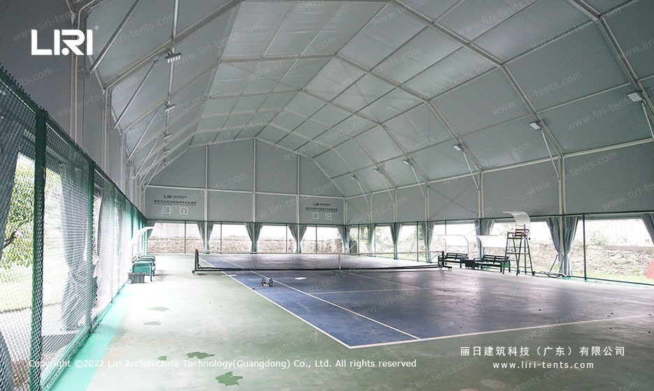 Clear-span interior of arcum-roof tennis hall with no internal columns