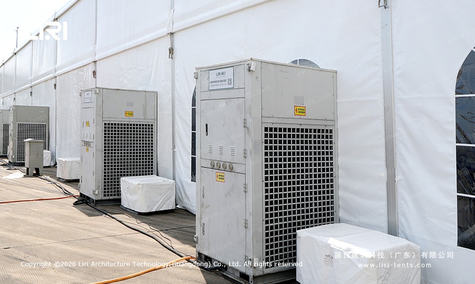 Industrial HVAC condensers along the outside of a clear span marquee at a race circuit