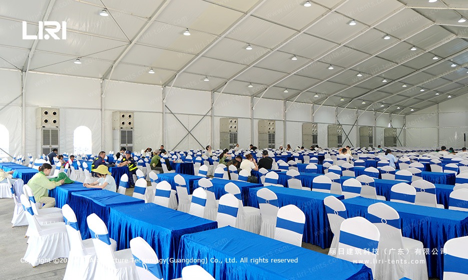Rows of banquet tables and chair sashes inside the clear span hall at a race weekend