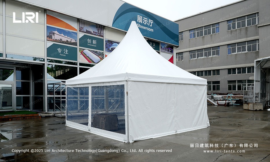 Pagoda gazebo with clear PVC sidewalls near showroom building