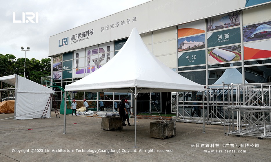 High peak pagoda marquee wide angle during crew installation at showroom
