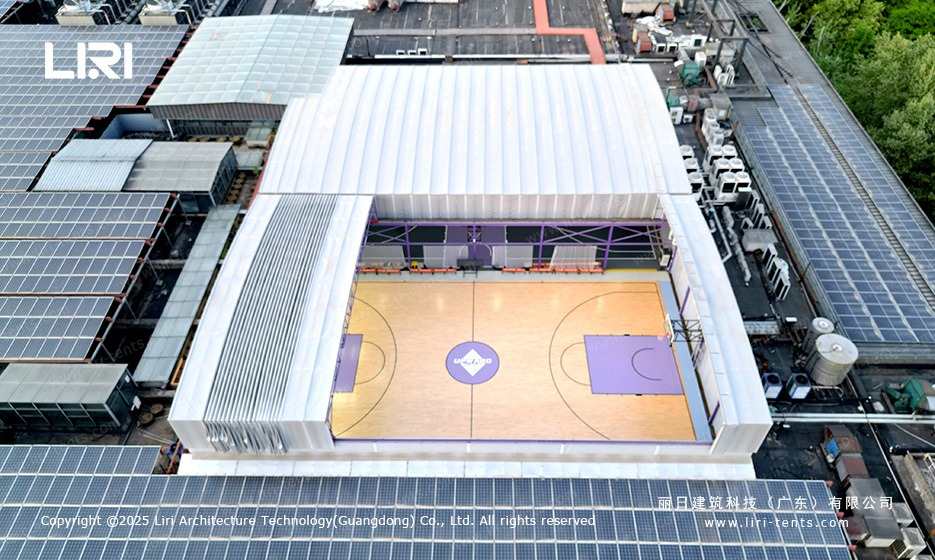 Purple gable marquee electric retractable roof open aerial of rooftop basketball court with purple key area