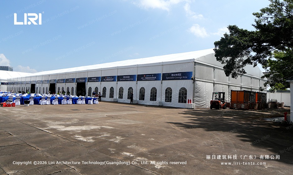 Long clear span marquee as race track spectator lounge with arched windows
