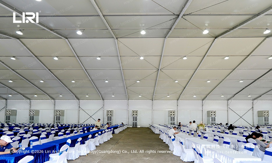 Wide angle view of the clear span spectator lounge with truss ceiling and banquet rows